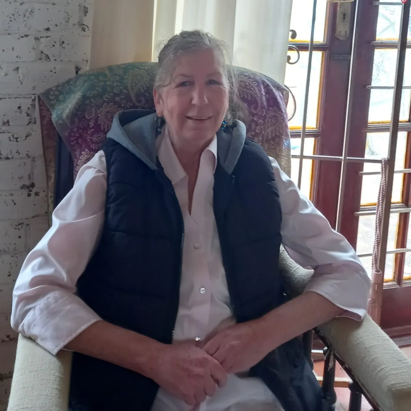 A bird sitting on a nest of eggs.