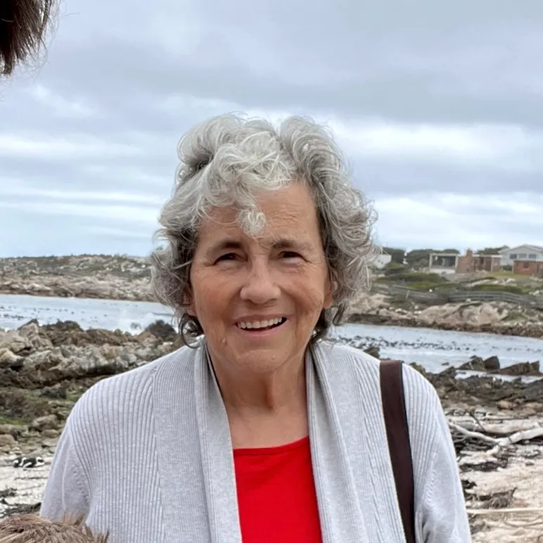 A bird sitting on a nest of eggs.